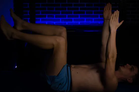 Dead bug exercise performed with the ribs held down