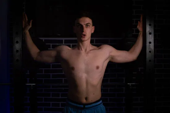 Mihail Veleski stretching the chest muscle against a wall